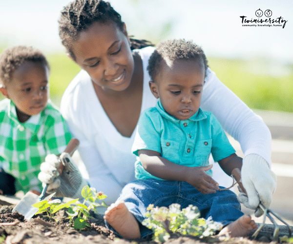 Mother and two boys gardening together