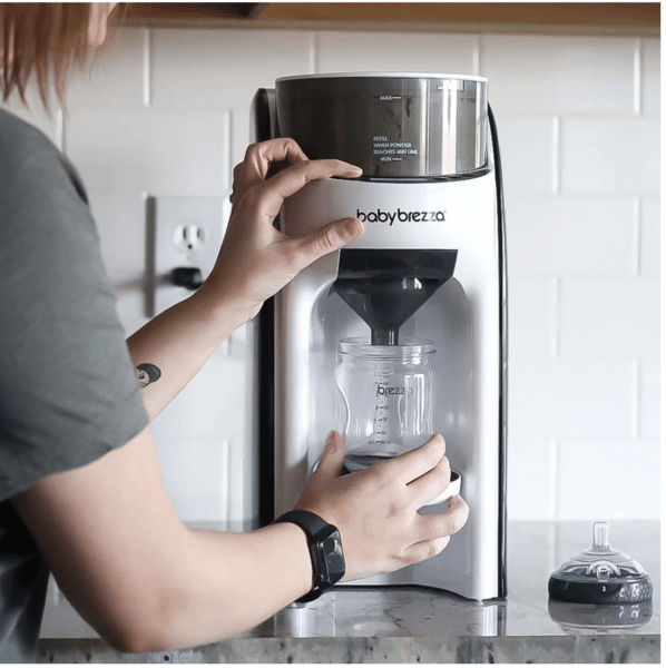 Image showing a mom using the product to warm up milk