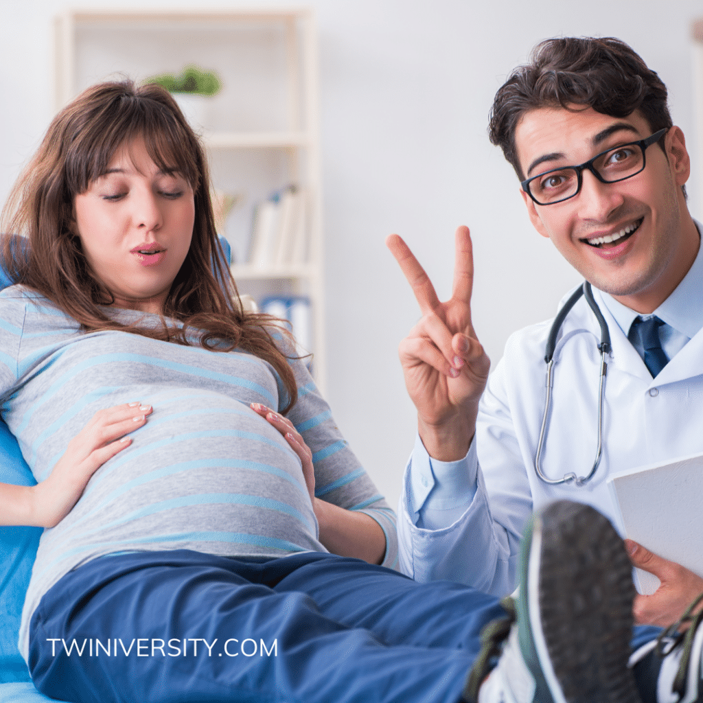 pregnant woman at doctor's appointment doctor holding up two fingers