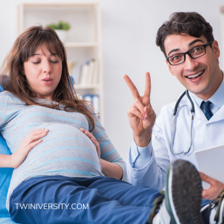 pregnant woman at doctor's appointment doctor holding up two fingers
