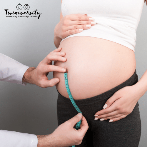 doctor measures the fundal height of a pregnant woman at her doctor's appointments