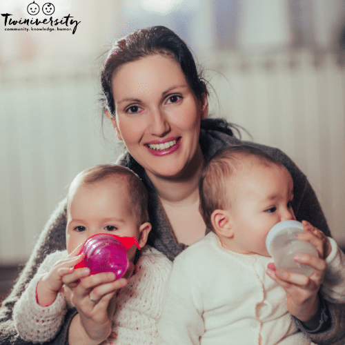 a woman manages her twins solo by feeding them at the same time