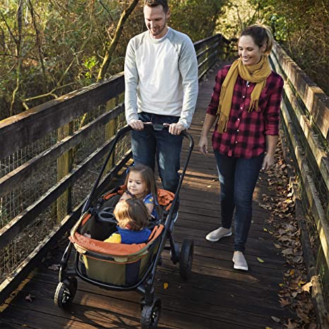 parents of twins use a stroller wagon on a walk