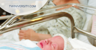 a woman in a hospital bed after giving birth to twins