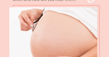pregnant woman holds a stethoscope to her belly to listen to her twins' heartbeats