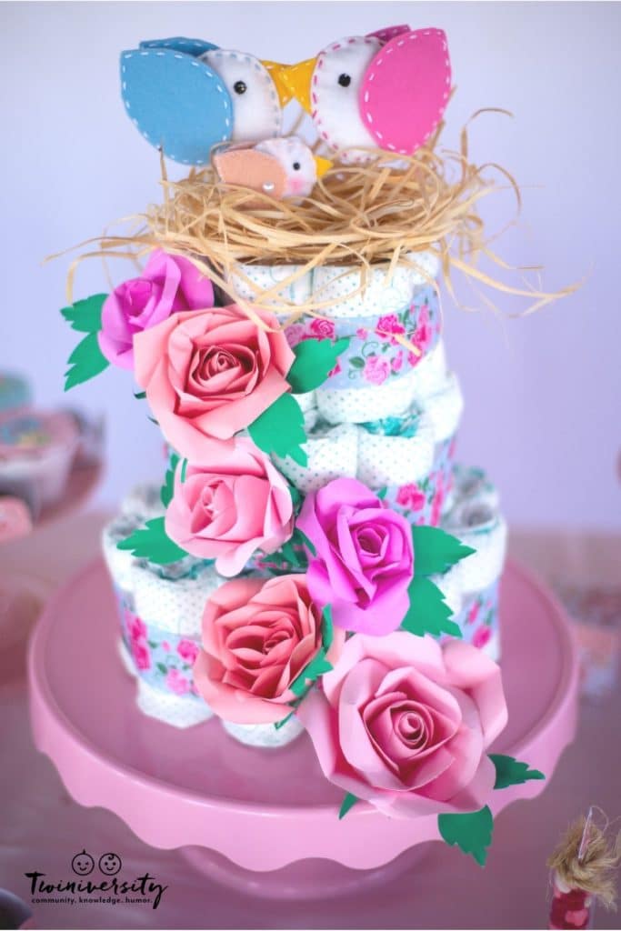 Three-tier cake made of rolled-up diapers. Perfect for a twin baby shower.