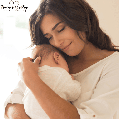 Mother holding baby to ensure no milk coming out of baby's nose