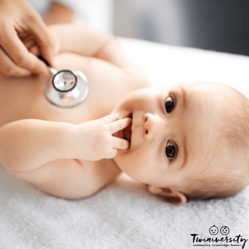 an infant gets an exam at the doctor's office to check if milk is coming out of baby's nose