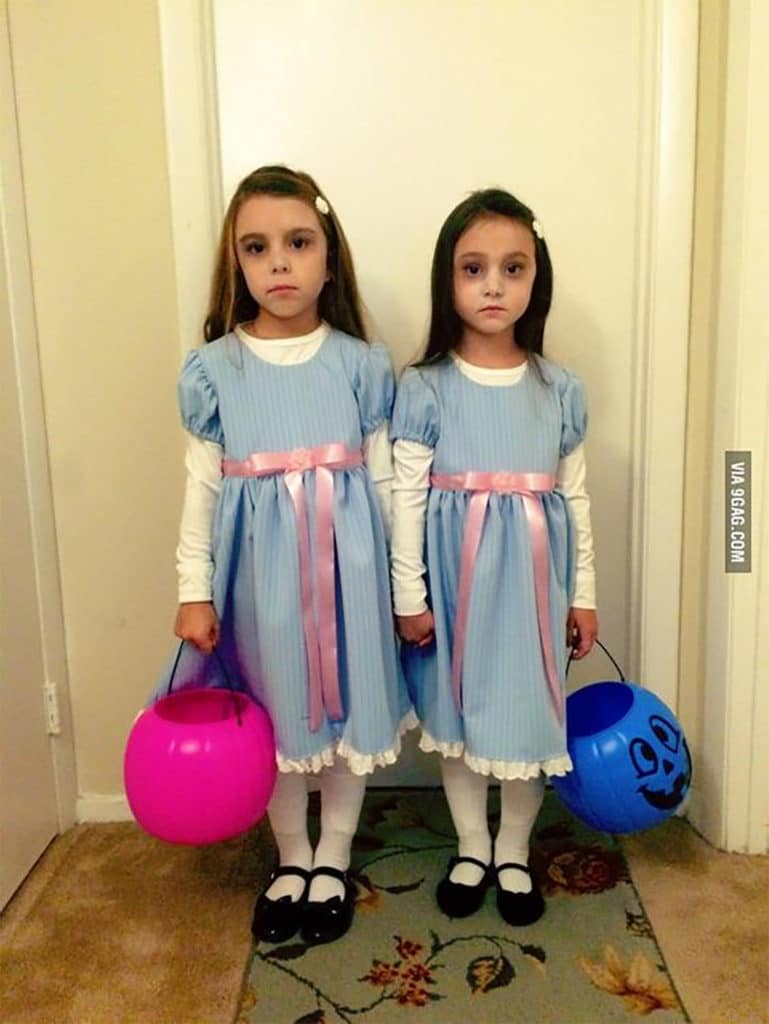 two young girls dressed in matching Shining Twins costumes