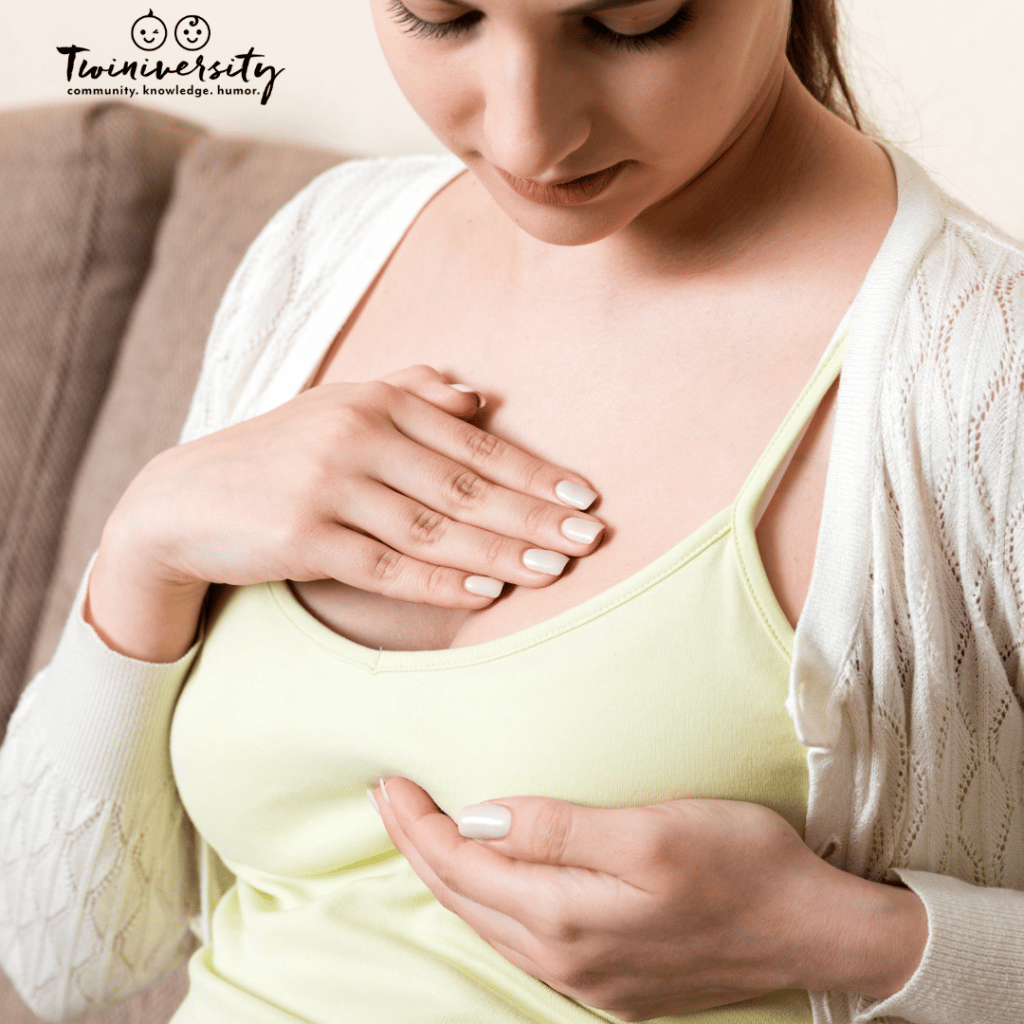 woman cupping breasts before hand expressing breast milk