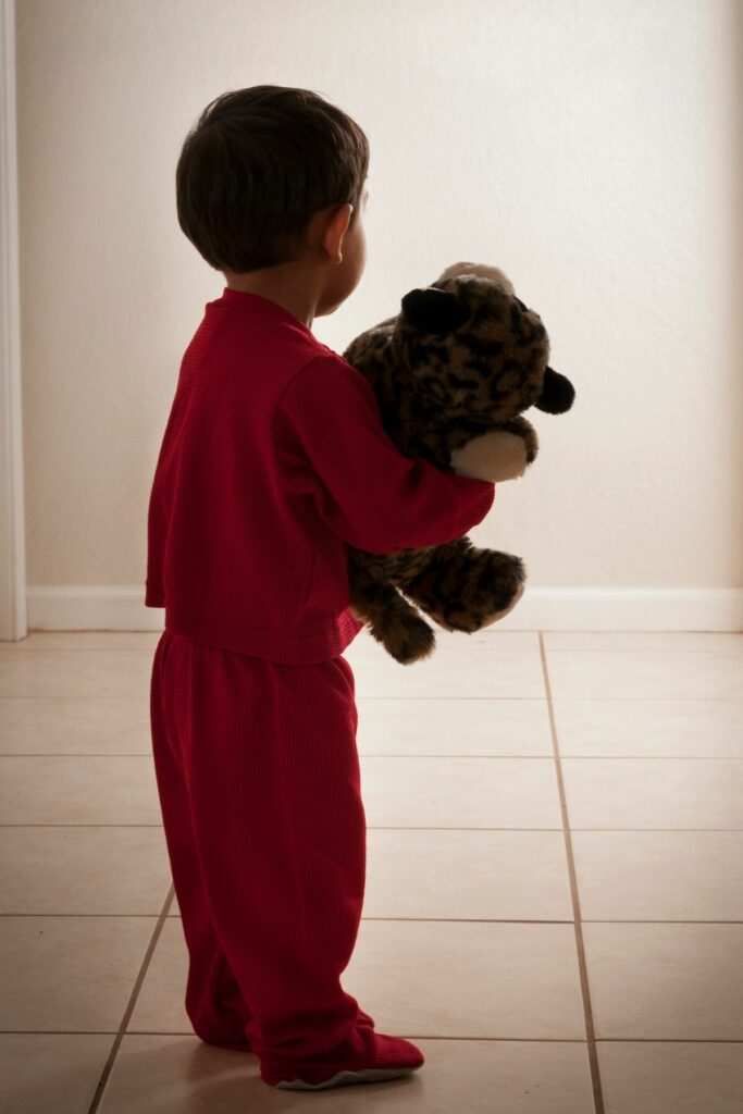 toddler in hallway wearing pajamas, not staying in bed