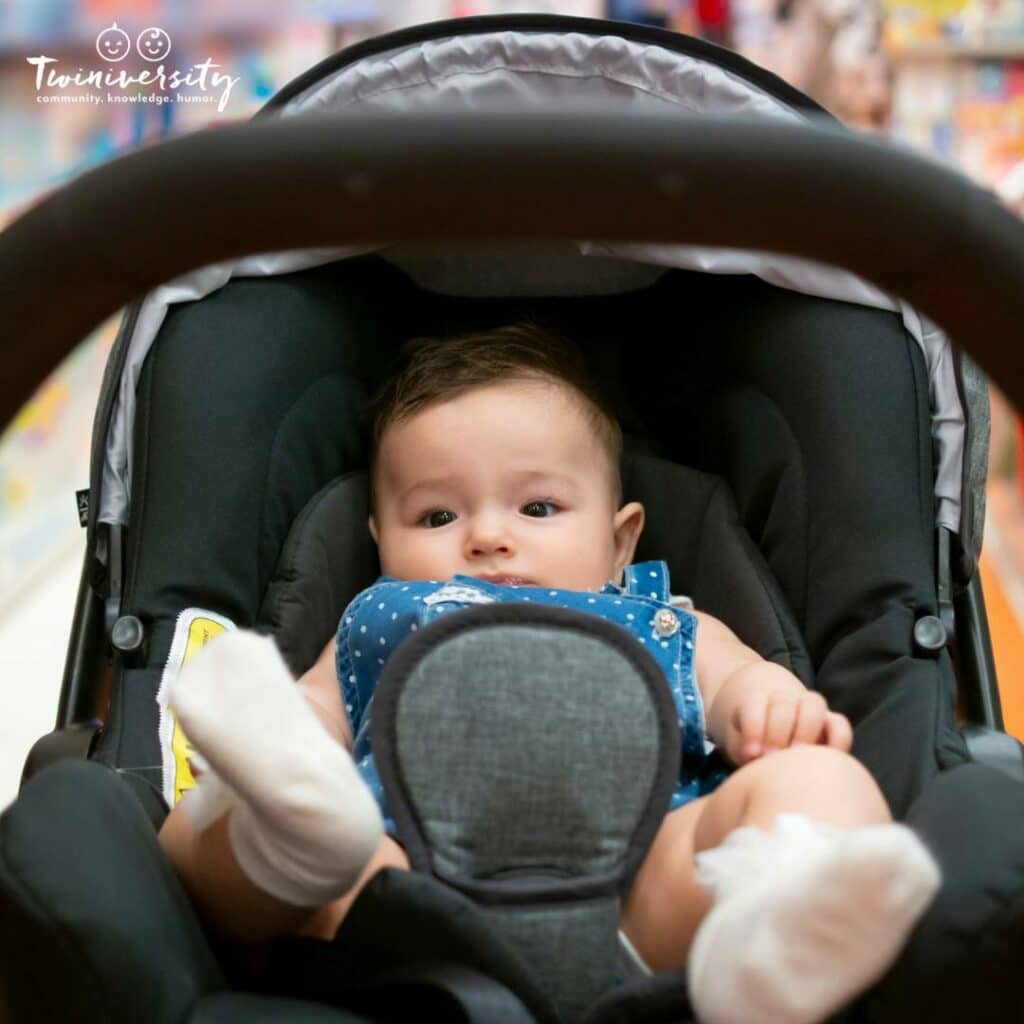 Baby in a stroller being pushed through the grocery store