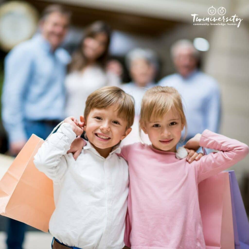 Boy/Girl twins with thier arms around each other and carrying shopping bags