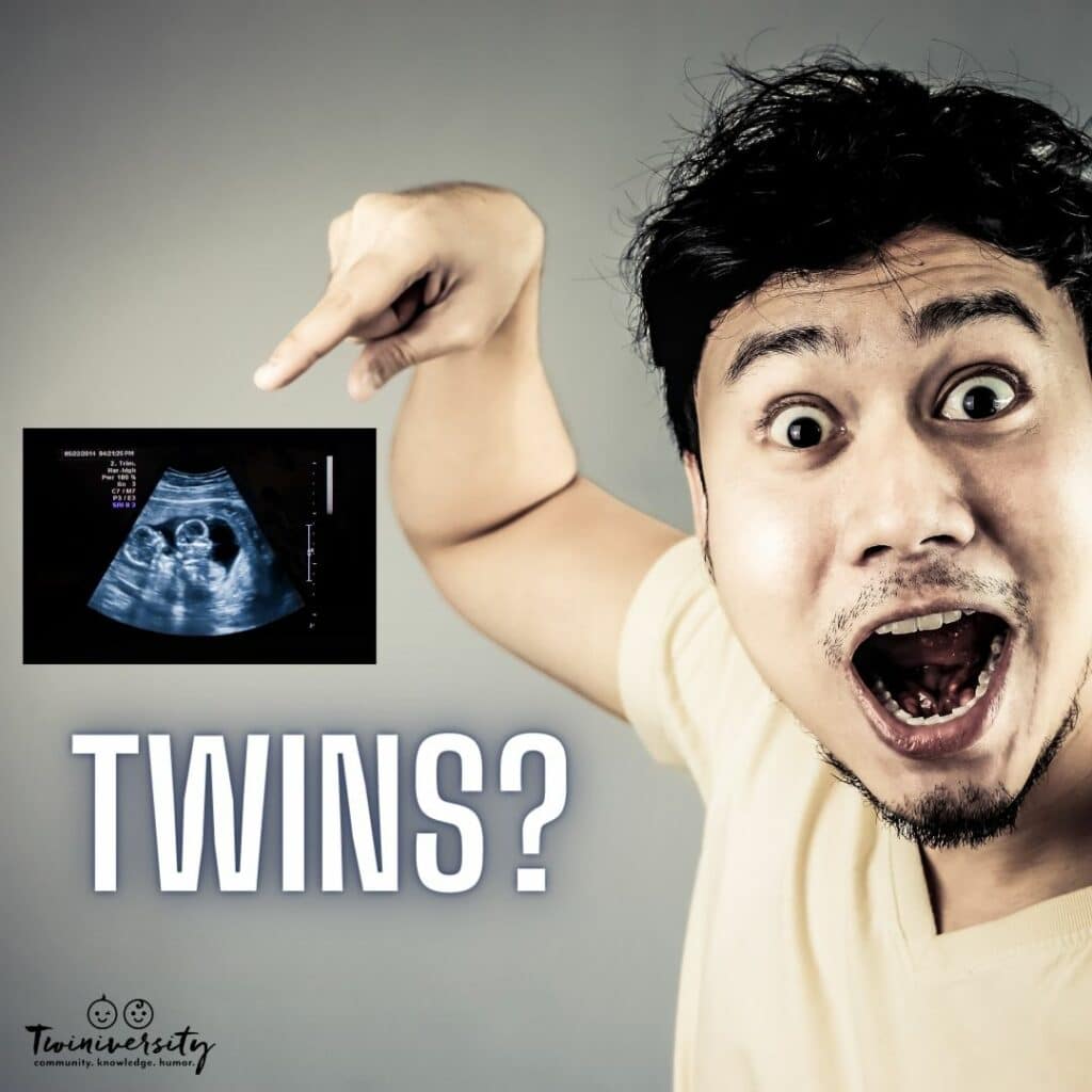 man pointing to a ultrasound of twins, shocked is his reaction to finding out it is twins
