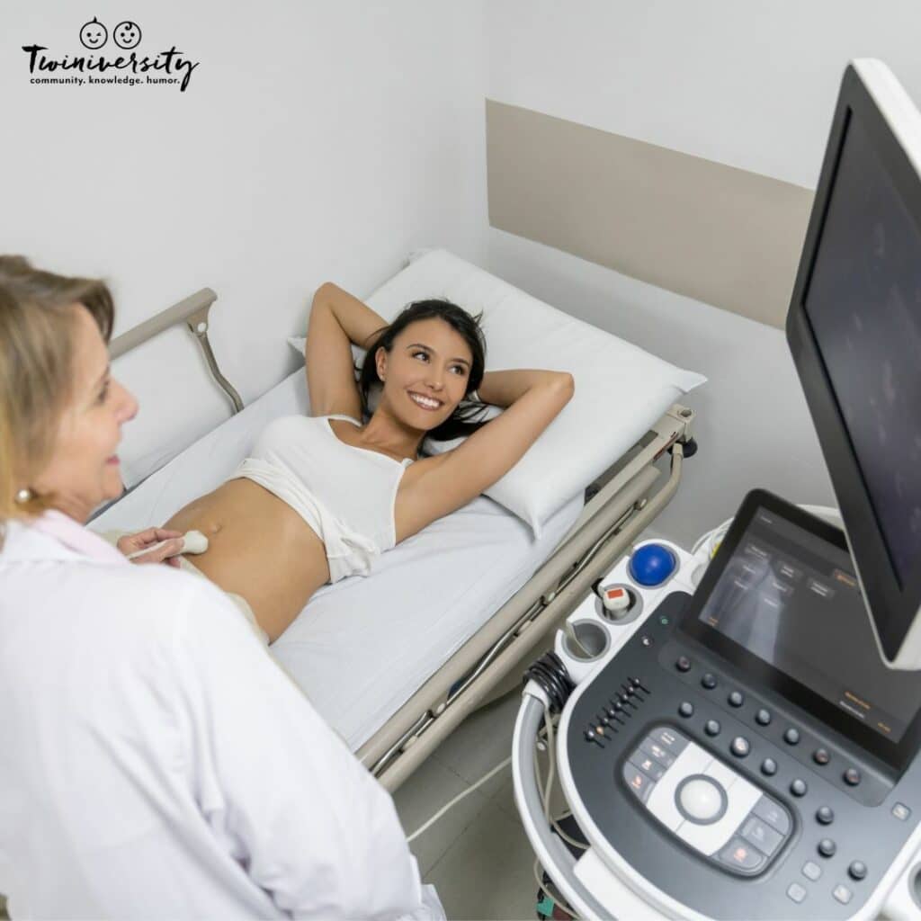 A lady lying on a hospital bed having an ultrasound done to see if she is having mono mono twins.
