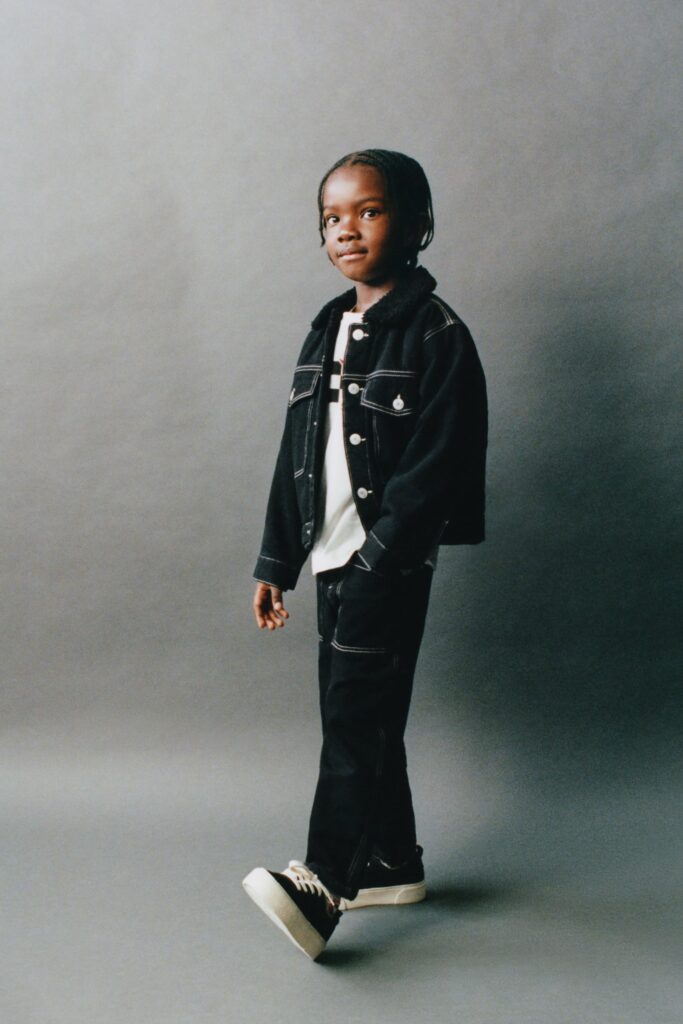 Little boy dressed in dark denim jacket and pants from Zara