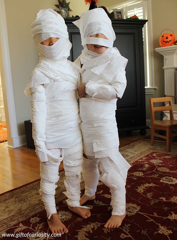 Twins dressed as Mummies from toilet paper