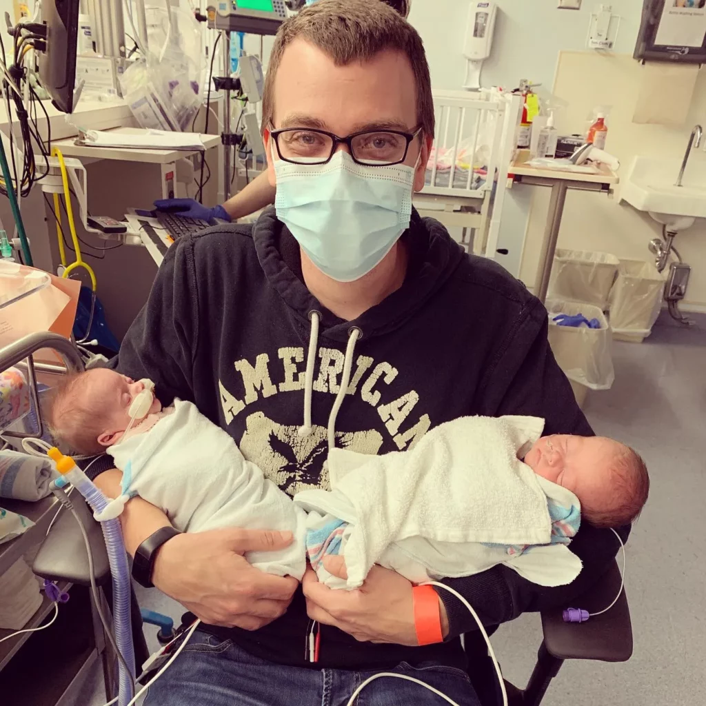 Dad holding babies in hospital