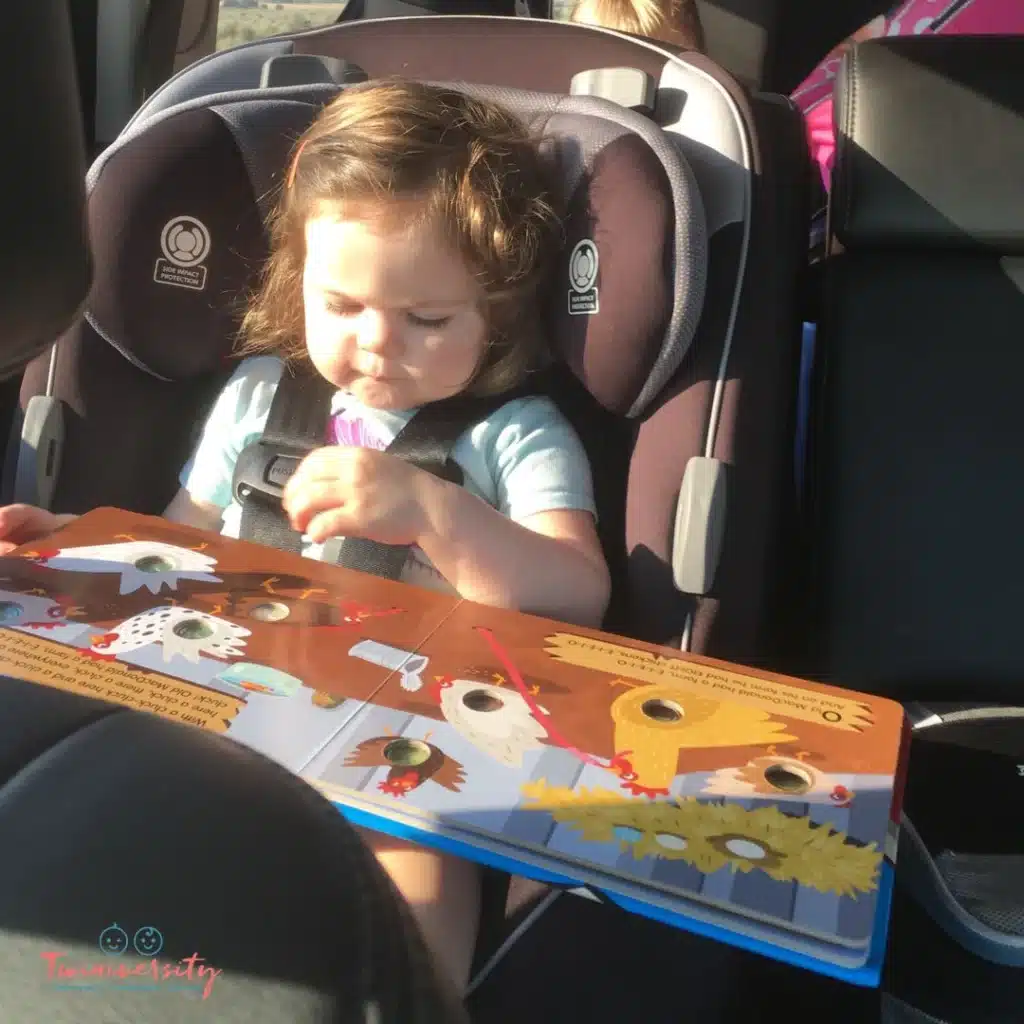 Toddler in car seat with sun shining right on them
