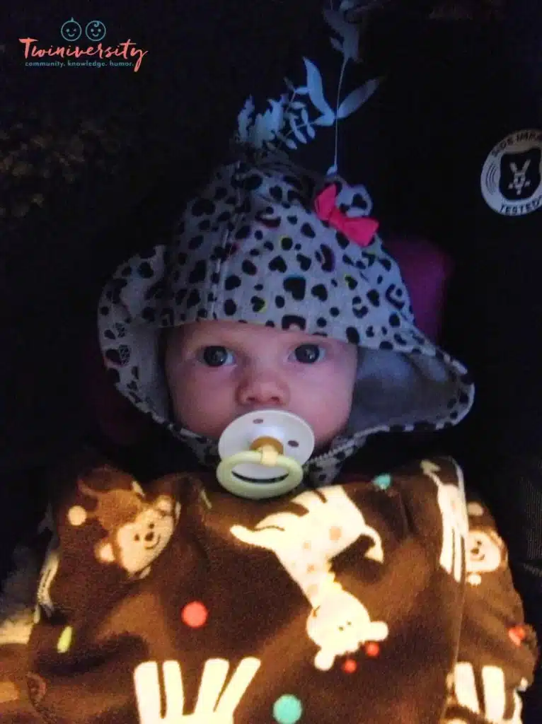 Baby in car seat with pacifer and blanket for comfort