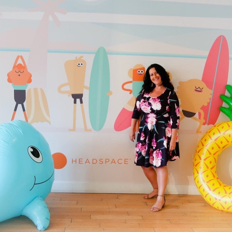 Nat in front of Summer themed Headspace wall