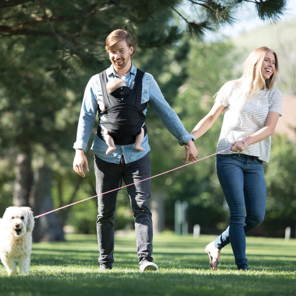 mom and dad in park truth about babywearing