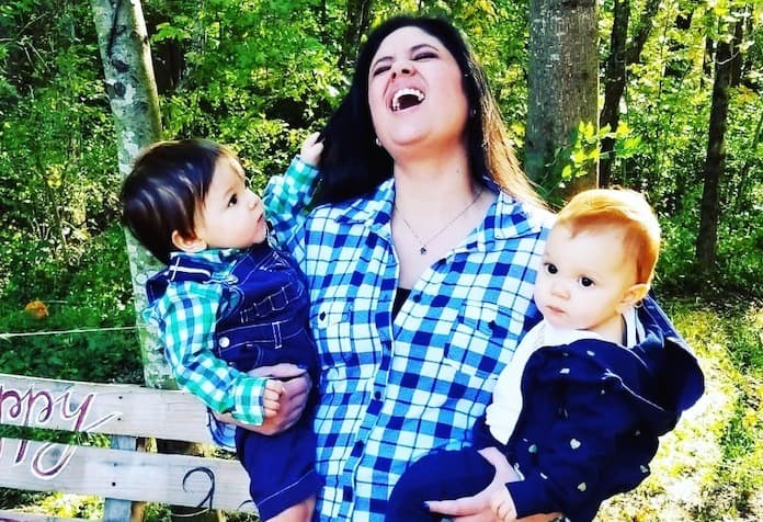 mom holding toddler twins in arms hot mess mom