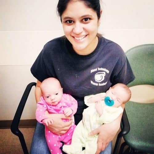 mom sitting in chair holding newborn twins hot mess mom