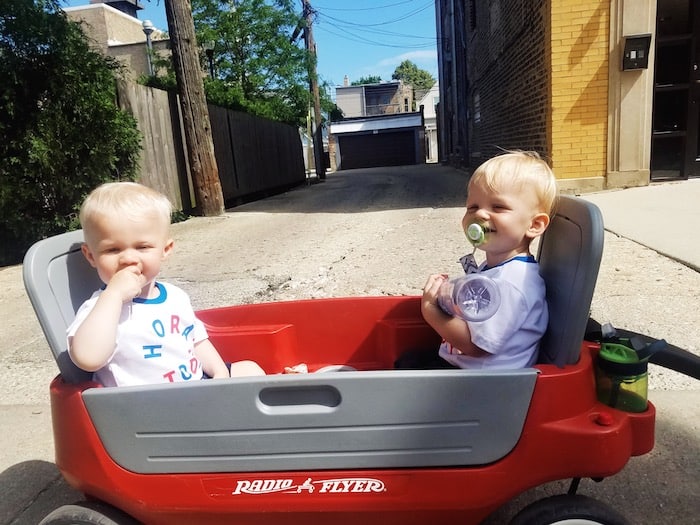 twin toddler boys sitting in a wagon toys that twins can share