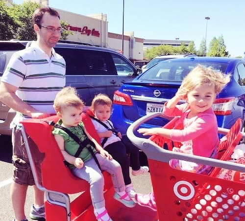 dad pushing little kids in a target shopping cart love language