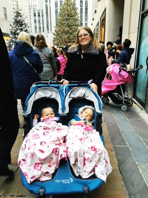 mom and twins in stroller at rockefeller center christmas tree nyc new traditions