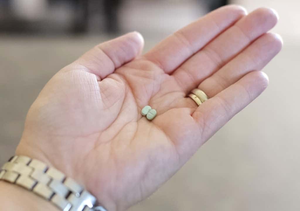 pills in woman's hand mom anxiety