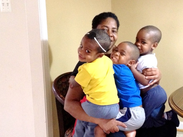 mom holding 3 kids deep clean