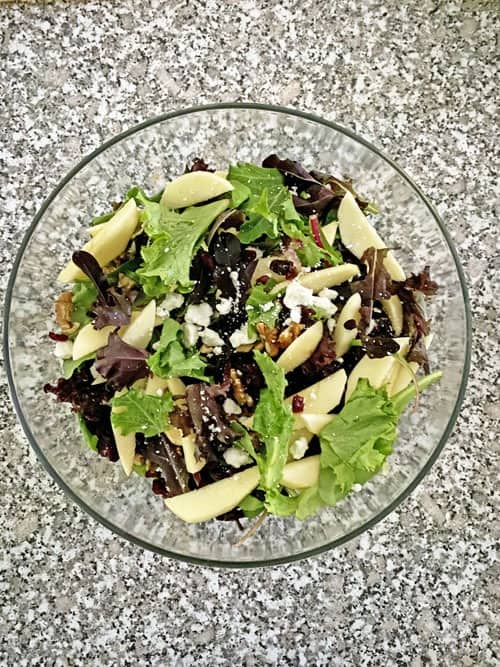 apple cranberry walnut salad in a glass bowl