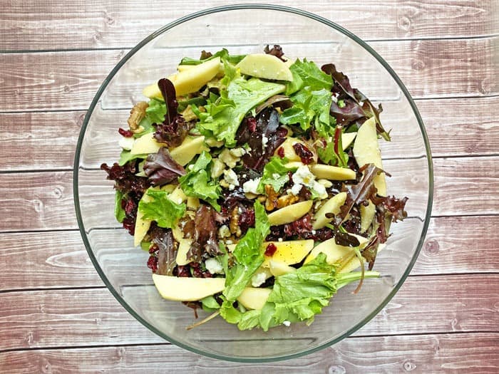 apple cranberry walnut salad in a glass bowl