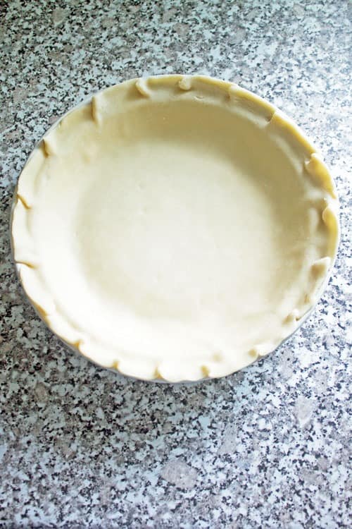 pressing crust into pie pan apple pie