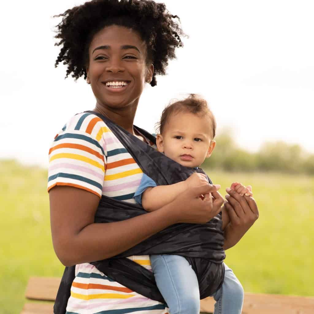 woman with baby in a baby carrier facing forward