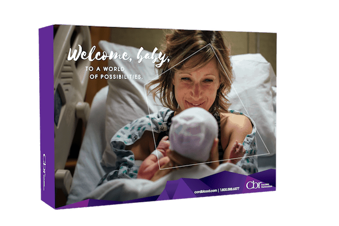 a woman holding a newborn with a hat on in a hospital bed shown on the cover of a CBR cord blood collection kit box. 