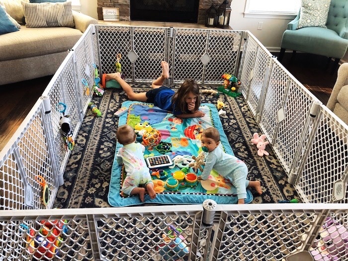 baby twins and older sister in a play yard Container Baby Syndrome