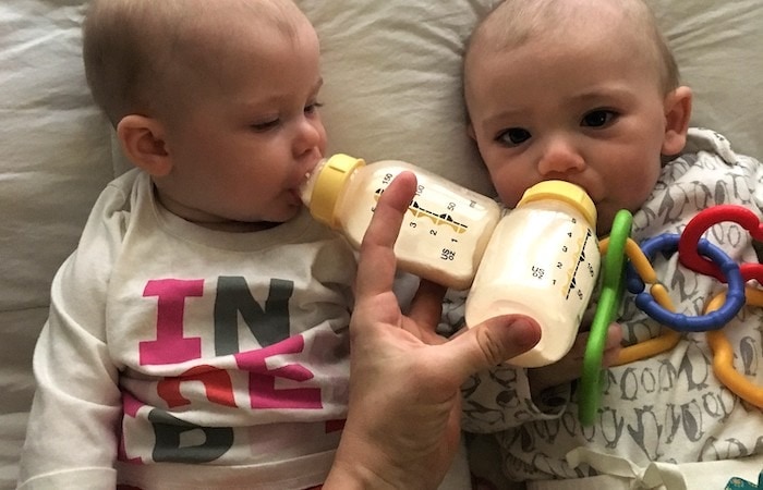 baby twins drinking from bottles mama of newborn twins
