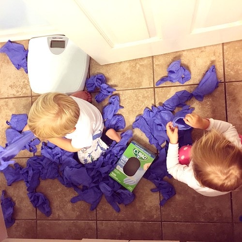 toddler twins pulling rubber gloves out of a box Keep Twins Busy