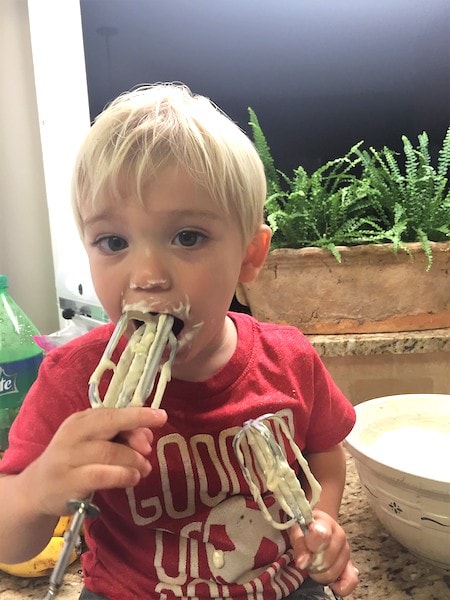 toddler boy eating batter off a hand mixer Keep Twins Busy