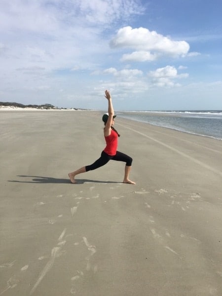 woman doing yoga on beach mindfulness