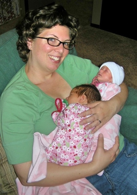 mom holding newborn twins reproductive assistance
