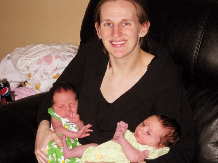 mom holding newborn twins exclusively breastfed twins