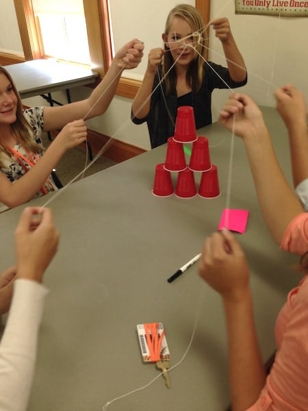 kids playing with strings and cups love of math