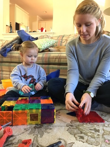 mom and child playing with magnatiles love of math