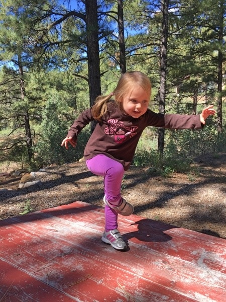 girl standing on bench preschool schedule