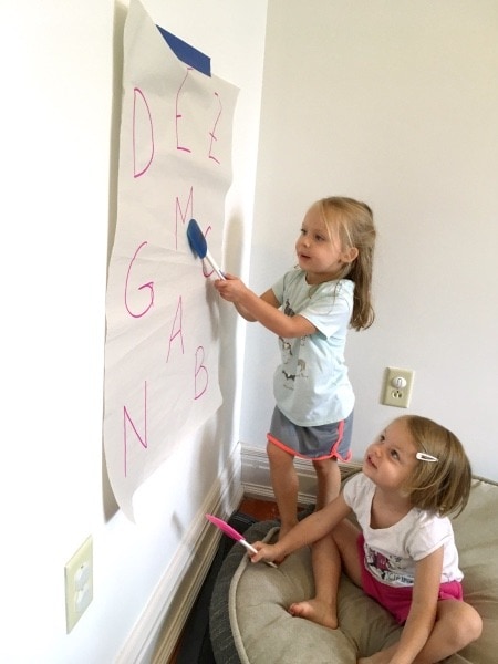 twin girls drawing on wall paper preschool schedule