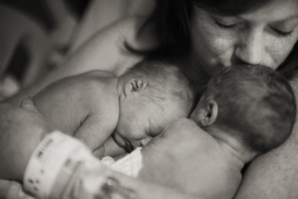 mom holding newborn twins idea of twins